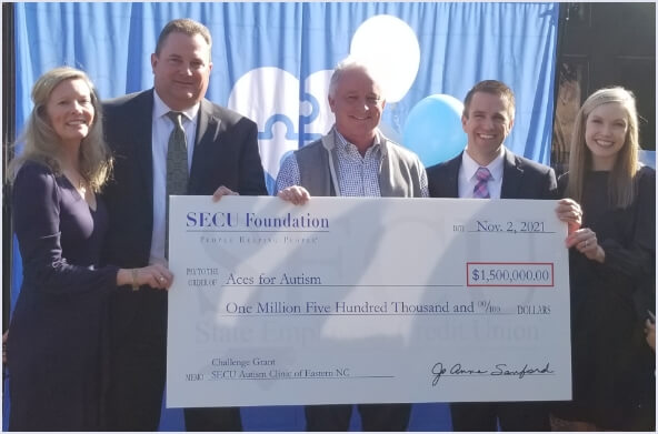 Image of check presentation to Aces for Autism for $1.5 million