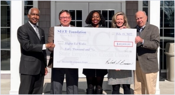Image of check presentation to Higher Ed Works