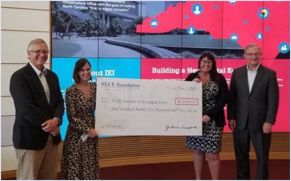 Group of people holding grant check