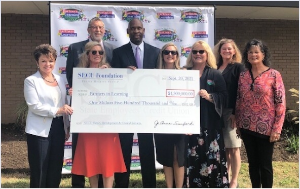 Image of check presentation to Partners in Learning for $1.5 million