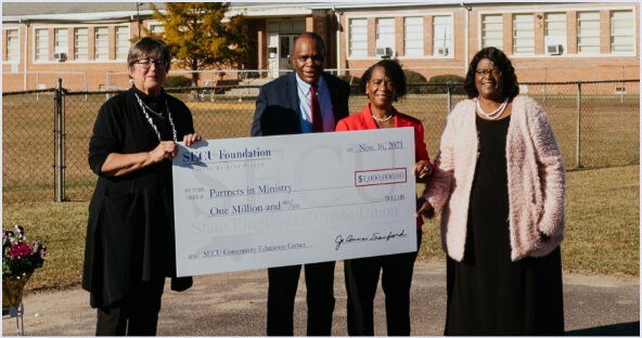 Check presentation to Partners in Ministry for $1 million