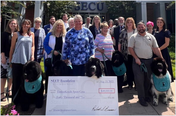 Large check presentation to TimberKnolls Spirit Cove from SECU Foundation